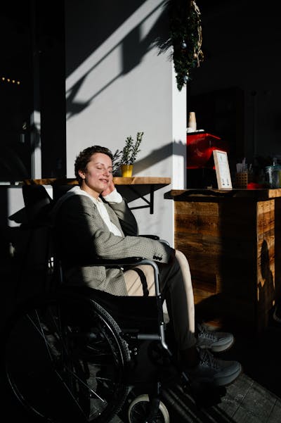 Happy woman in wheelchair in bright room